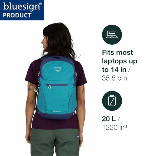 Person wearing a blue backpack with laptop compatibility details.