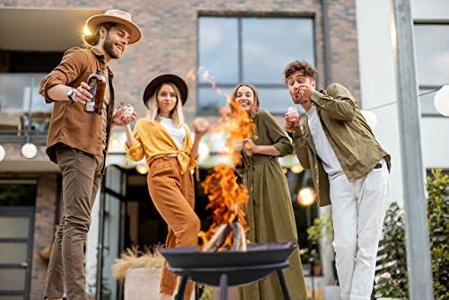 Group of friends having fun at an outdoor party with a fire pit.