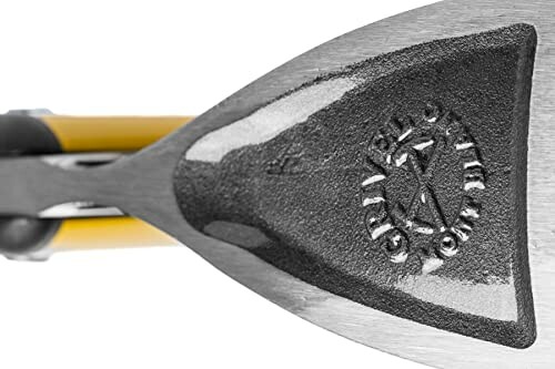 Close-up of an ice axe pick with logo engraving